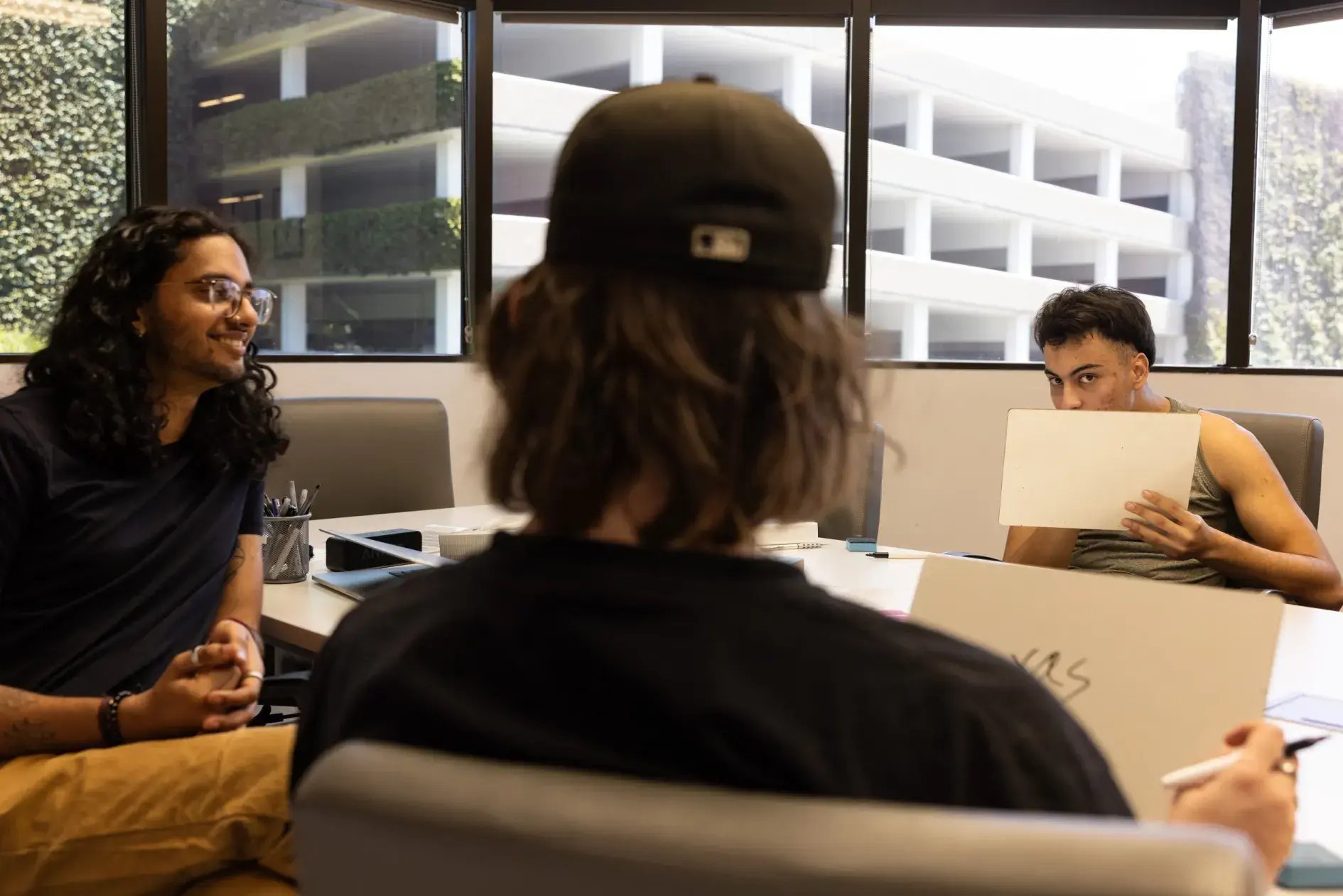 Jaime Meza, right, working on an exercise to better read the expressions of others, under the direction of Arnav Amit, a mental-health technician, at California OnTrack.