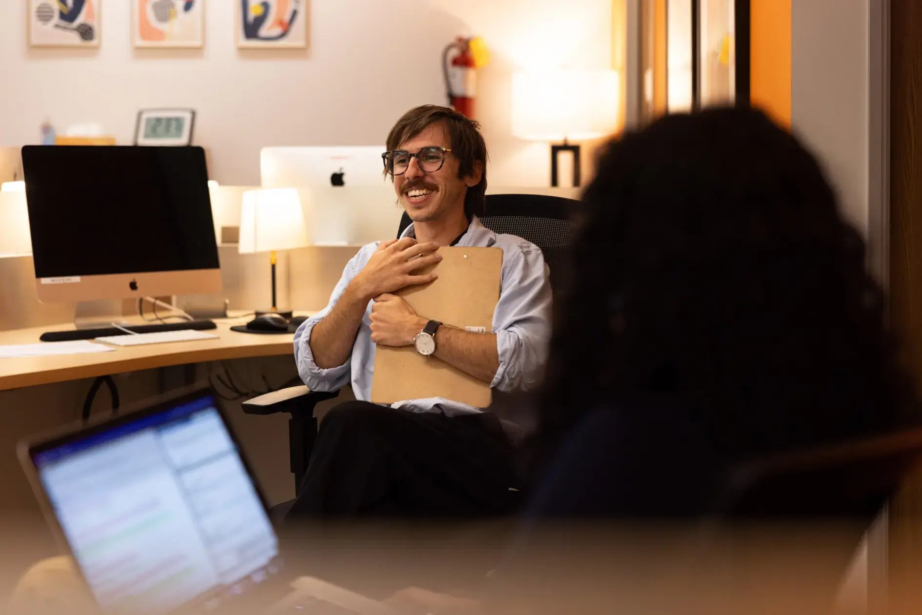 Kyle Menschel, a therapist at California OnTrack, speaking with a co-worker.