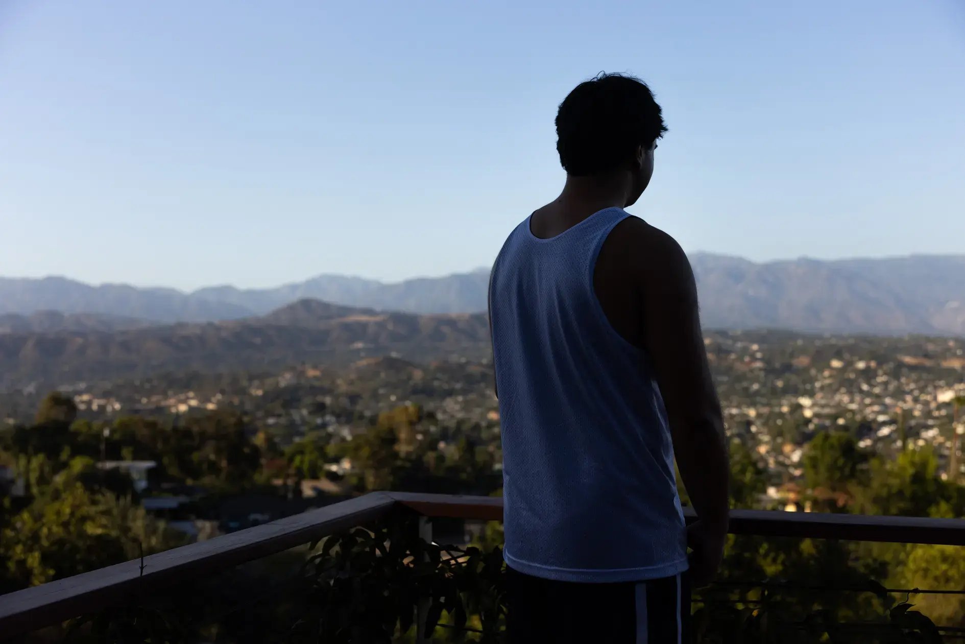 Noah Hudnut looking out from the balcony of his family‘s house in Los Angeles.